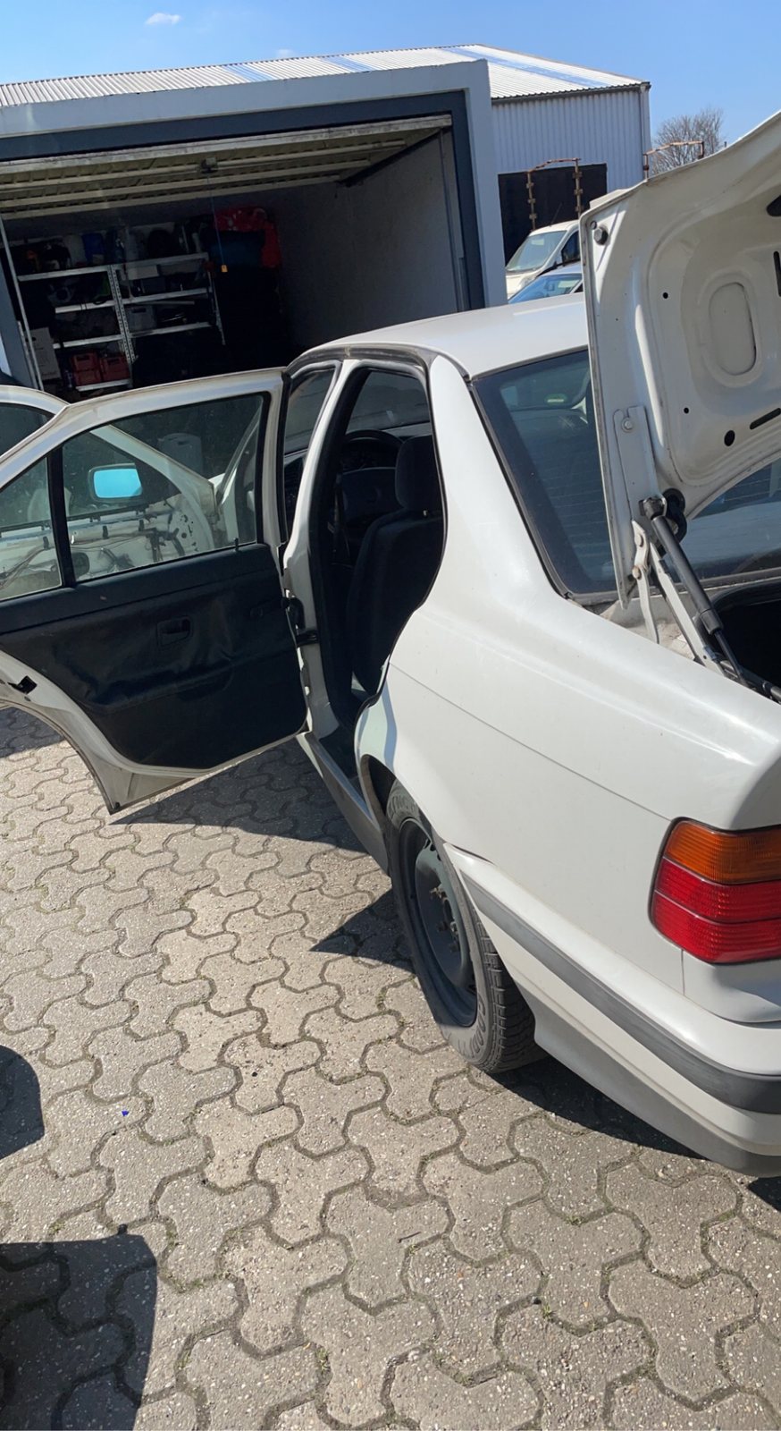 Seitliche Bestandsaufnahme des BMW E36 mit geöffneten Türen